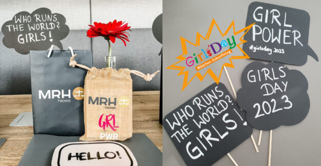 Dekorierter Tisch mit MRH Trowe Giveaways zum Girls’Day 2023, darunter ein Jutebeutel mit „GRL PWR“, eine gelbe Blume und ein Schild mit „GIRL POWER“