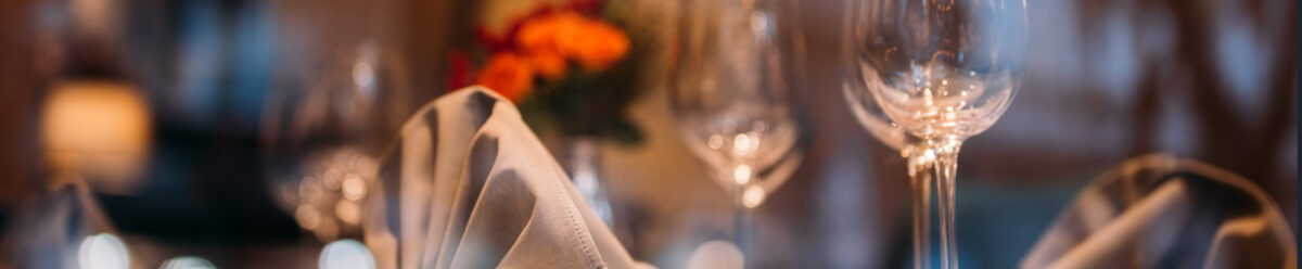 Elegant gedeckter Restauranttisch mit Weingläsern und Blumen